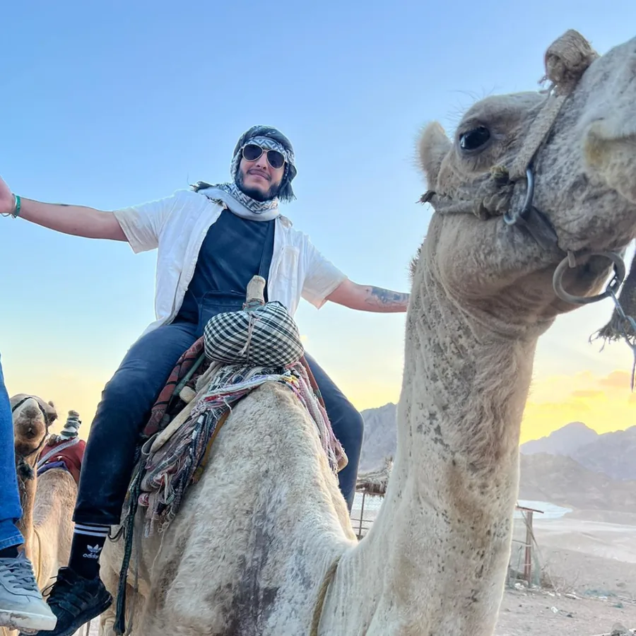 Kevin sitting on a camel