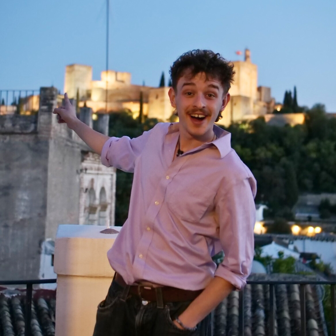 Picture of Oisín excitedly infront of a castle